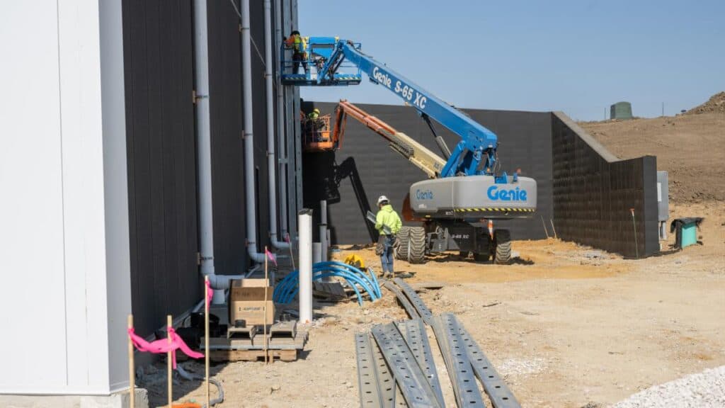 Workers Installing Exterior Wall Panels Lift